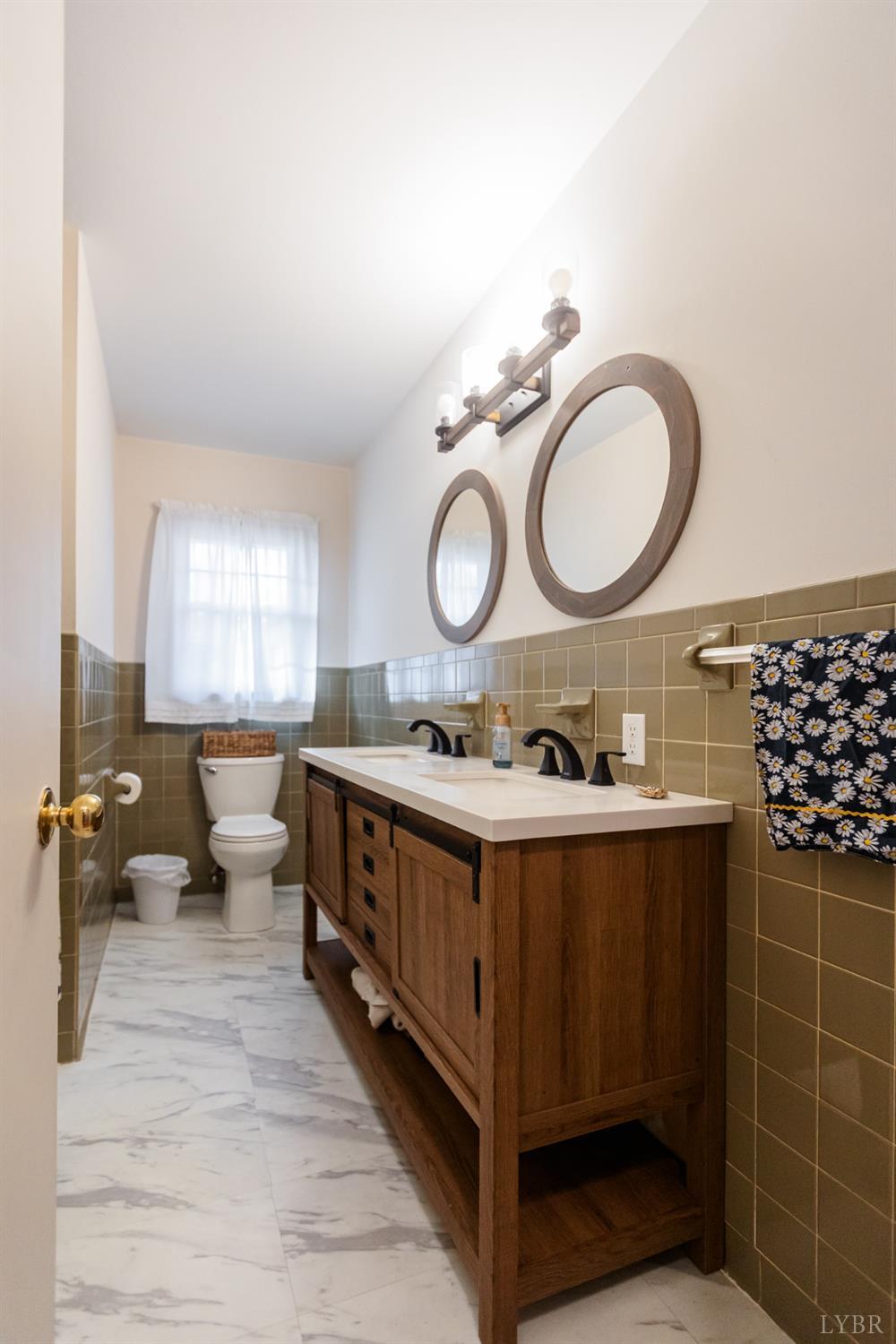 10769 Oakville Road Gladstone, VA 24553 - Photo 14 of 35 a spacious bathroom with a double vanity sink toilet mirror and window
