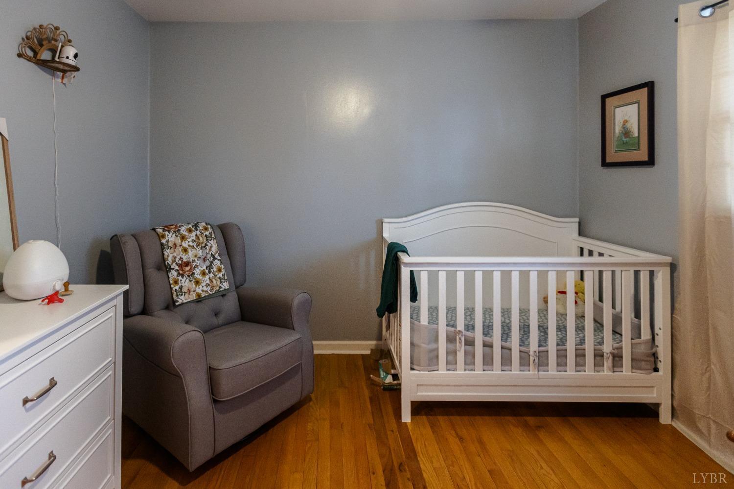 10769 Oakville Road Gladstone, VA 24553 - Photo 19 of 35 a bedroom with a bed and wooden floor