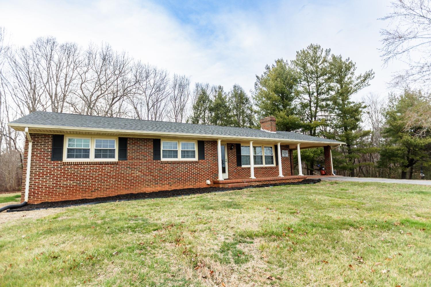 10769 Oakville Road Gladstone, VA 24553 - Photo 2 of 35 a front view of a house with a garden