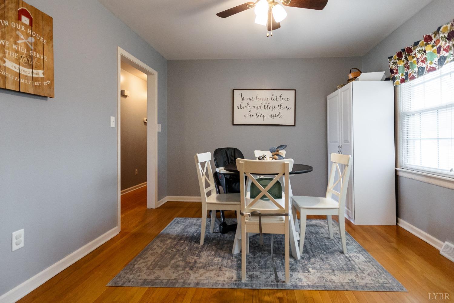 10769 Oakville Road Gladstone, VA 24553 - Photo 10 of 35 a dining room with wooden floor and a chandelier