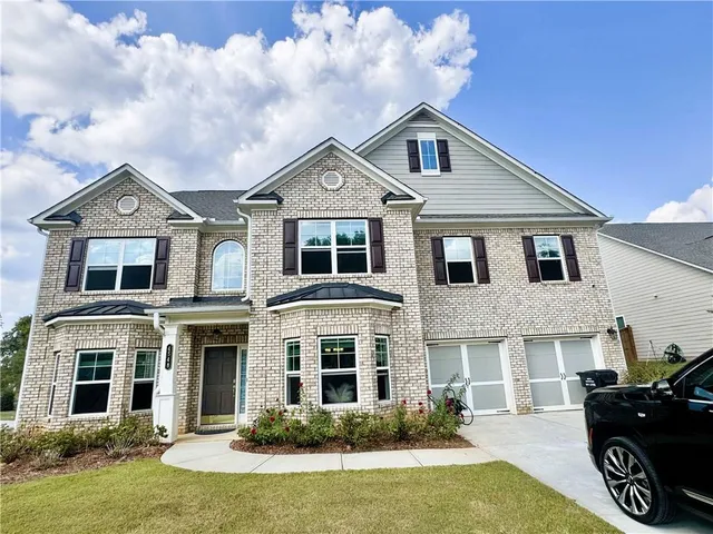 a front view of a house with yard