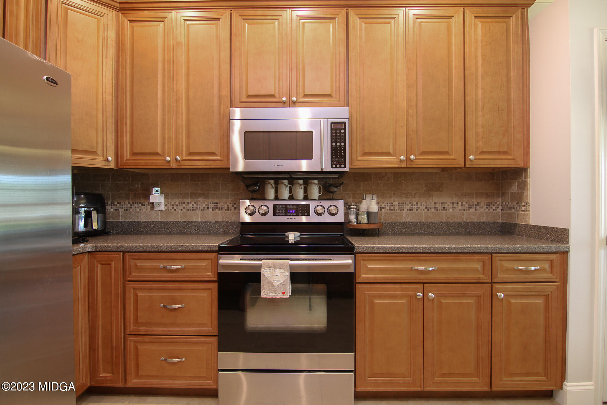 110 Berkley Circle Warner Robins, GA 31093 - Photo 17 of 57 a kitchen with stainless steel appliances granite countertop wooden cabinets and a stove top oven