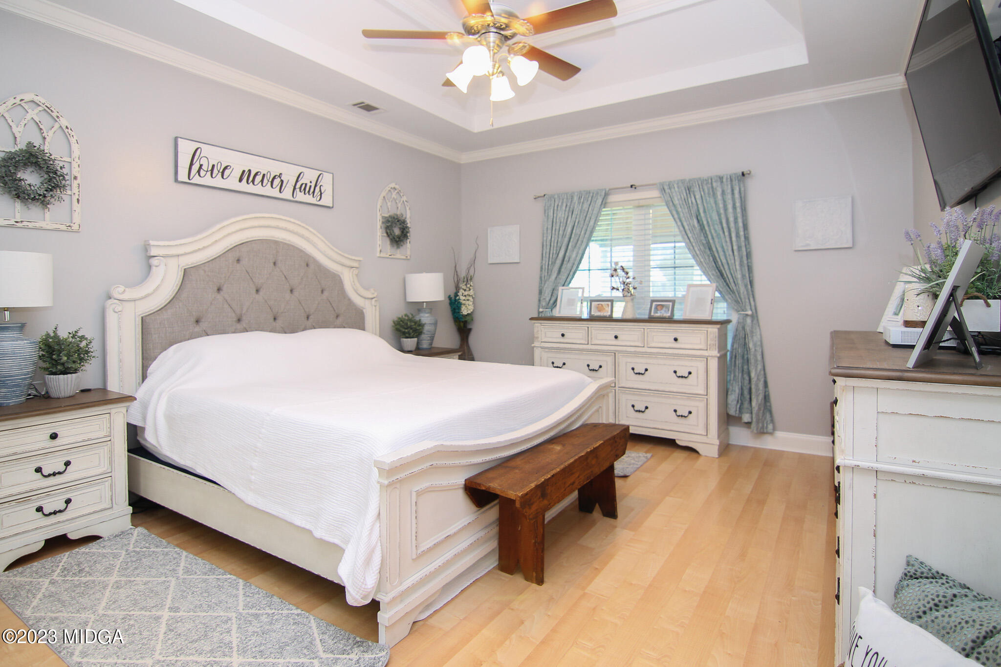 110 Berkley Circle Warner Robins, GA 31093 - Photo 19 of 57 a spacious bedroom with a bed and a flat tv screen on dresser