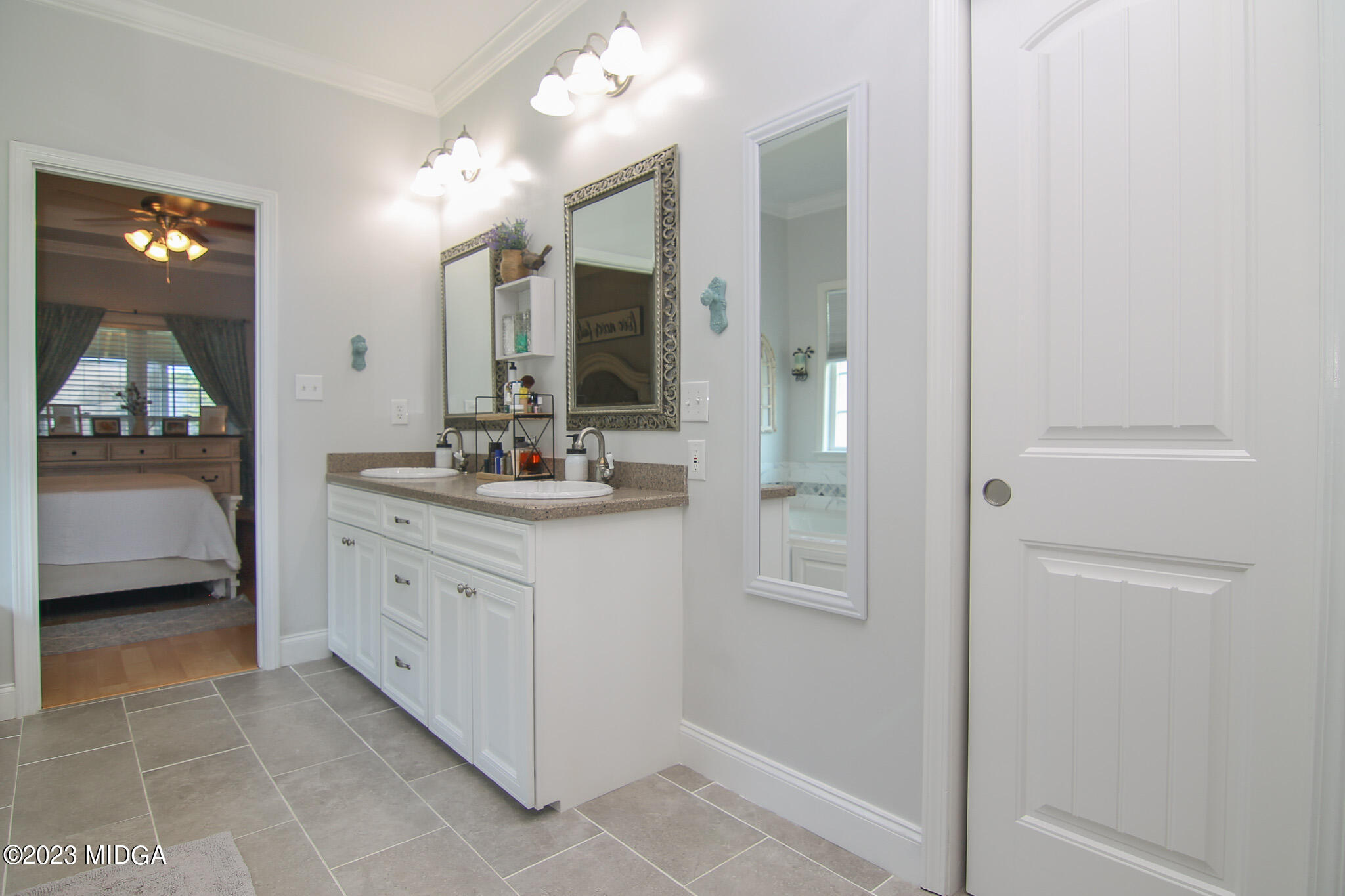 110 Berkley Circle Warner Robins, GA 31093 - Photo 25 of 57 a bathroom with a double vanity sink and mirror