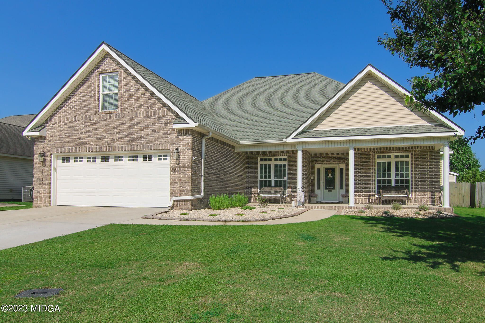 110 Berkley Circle Warner Robins, GA 31093 - Photo 3 of 57 a front view of a house with a garden and yard