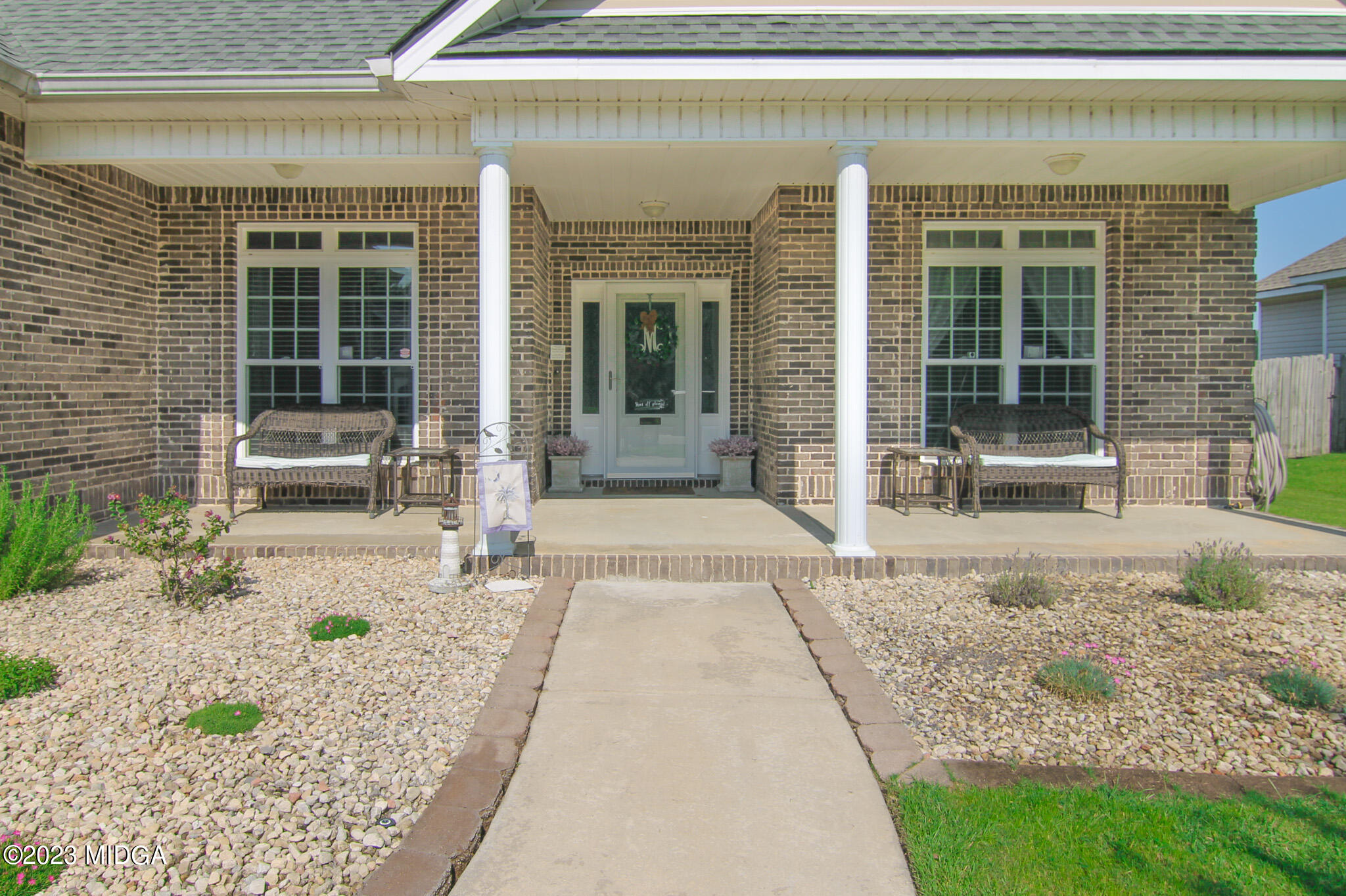 110 Berkley Circle Warner Robins, GA 31093 - Photo 5 of 57 a front view of a house with outdoor seating and plants