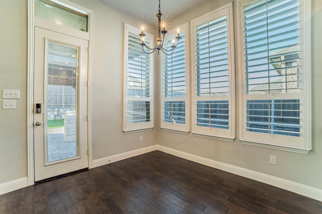 3503 Jersey Road Melissa, TX 75454 - Photo 24 of 40 Unfurnished dining area with dark wood-style flooring, healthy amount of natural light, and a chandelier