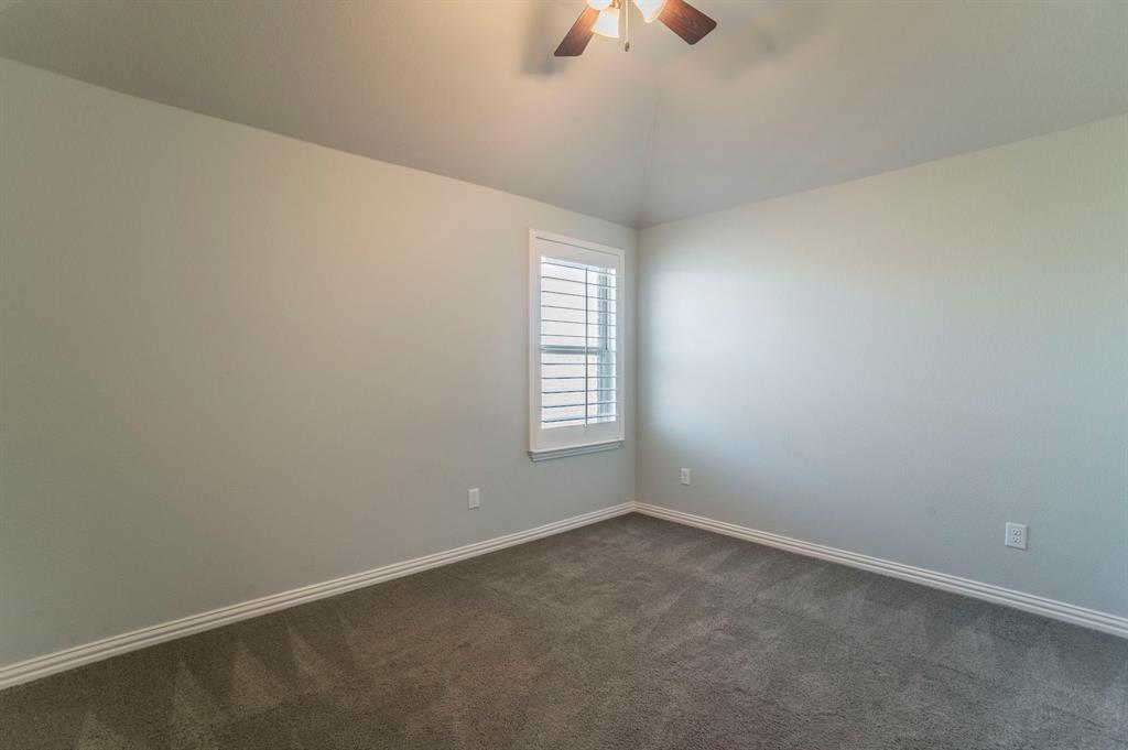3503 Jersey Road Melissa, TX 75454 - Photo 35 of 40 Unfurnished room with dark carpet, vaulted ceiling, and ceiling fan