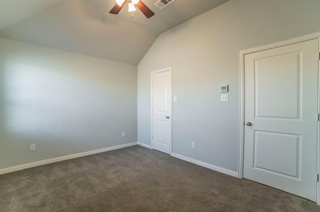 3503 Jersey Road Melissa, TX 75454 - Photo 36 of 40 Unfurnished bedroom featuring lofted ceiling, dark carpet, and ceiling fan