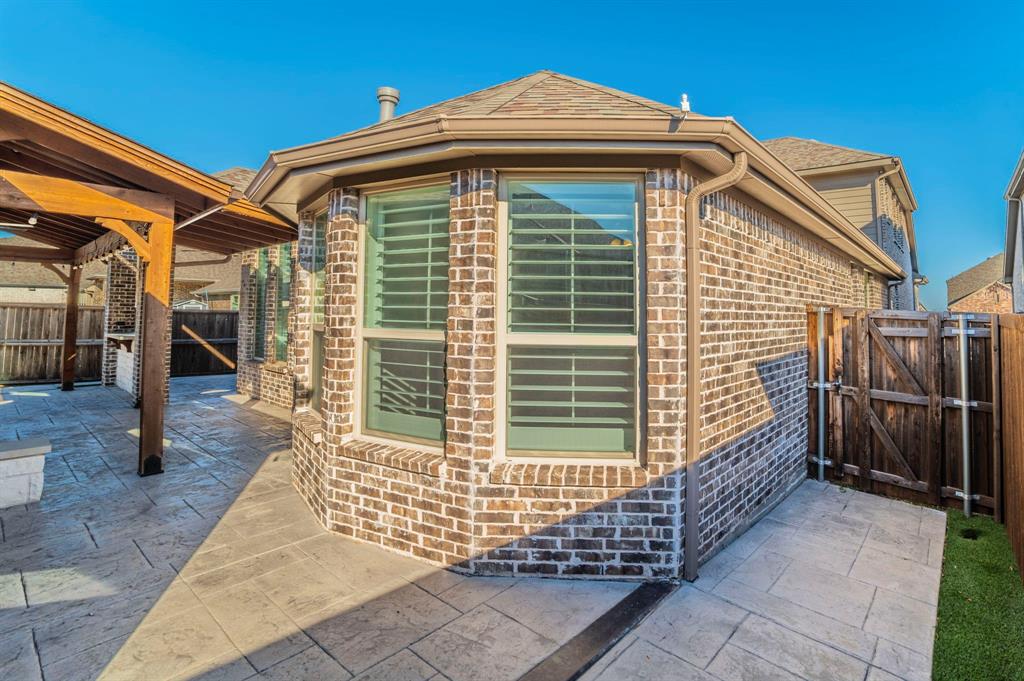 3503 Jersey Road Melissa, TX 75454 - Photo 40 of 40 View of home's exterior featuring brick siding, a gate, and a patio area