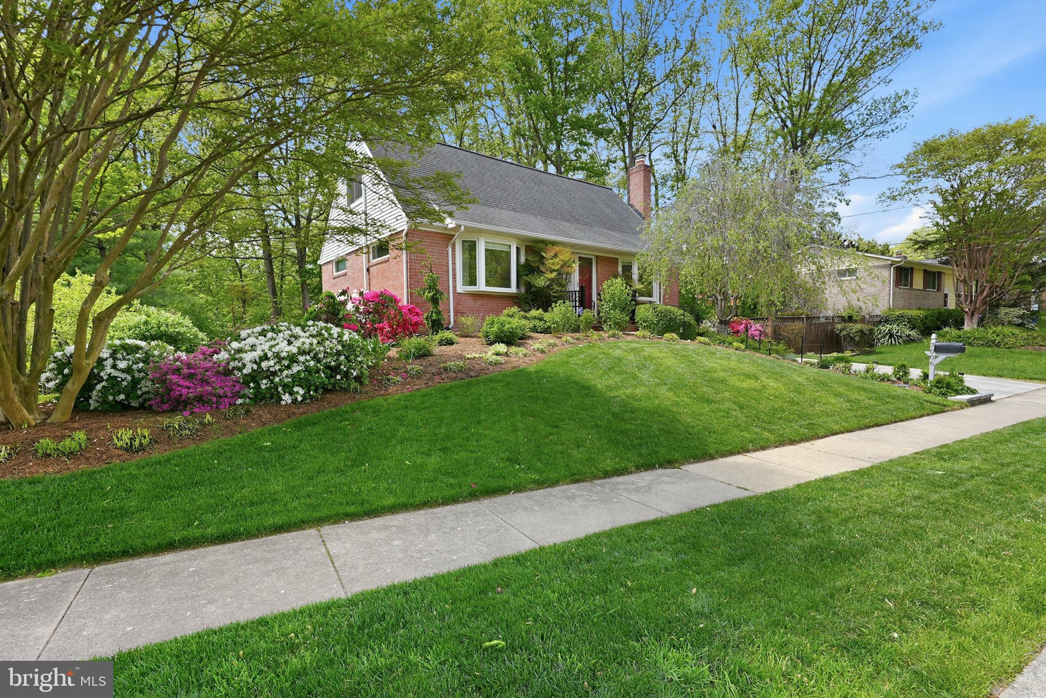 7006 Barnack Drive Springfield, VA 22152 - Photo 45 of 56 a front view of a house with a garden