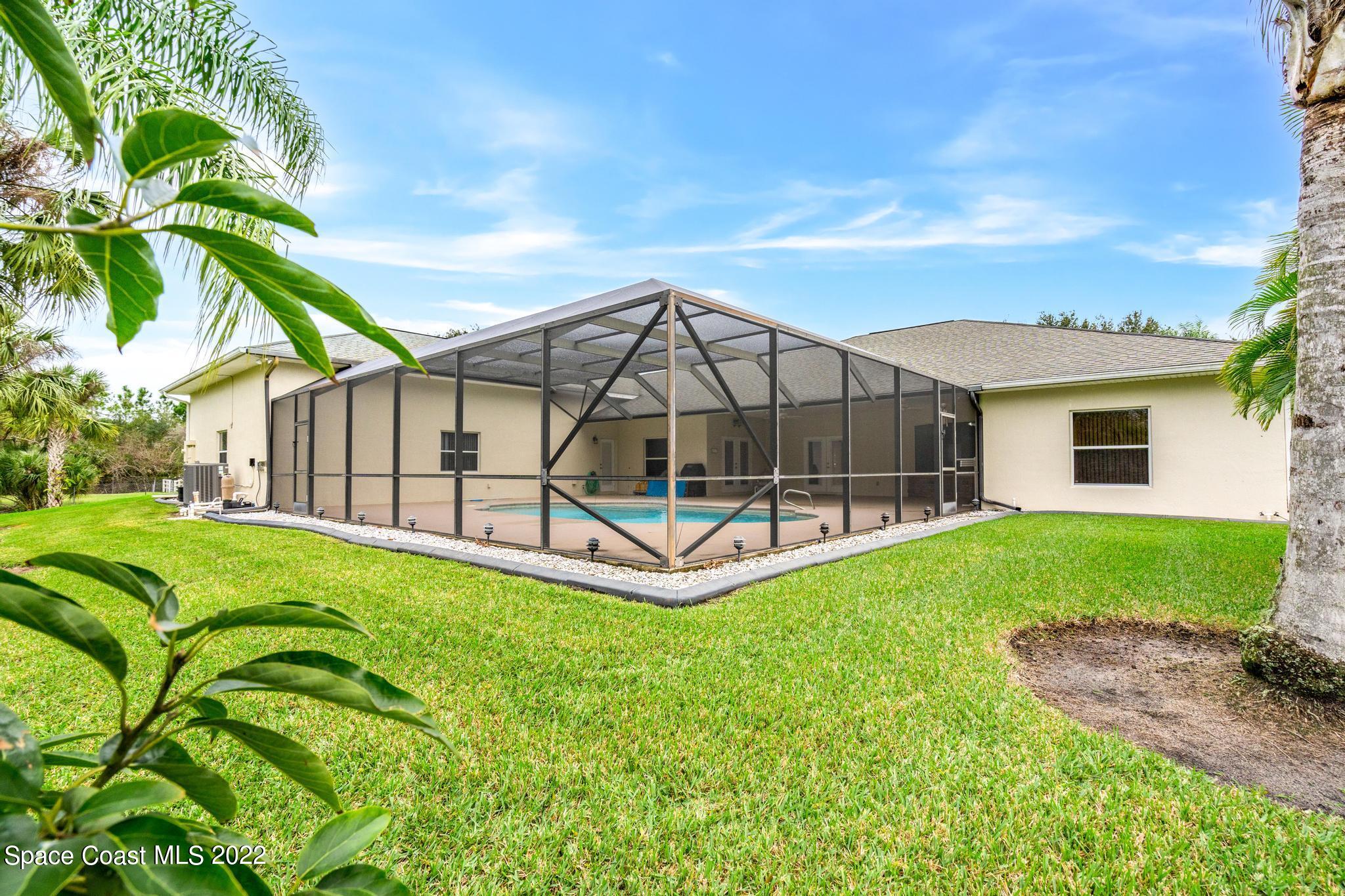 3970 Harlock Road Melbourne, FL 32934 - Photo 21 of 30 a view of backyard with deck and garden