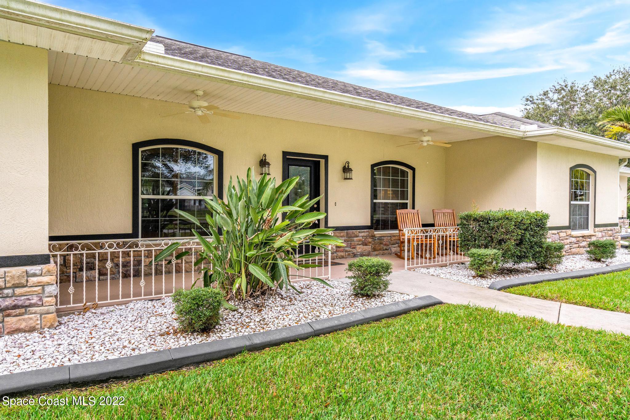 3970 Harlock Road Melbourne, FL 32934 - Photo 3 of 30 a front view of a house with garden