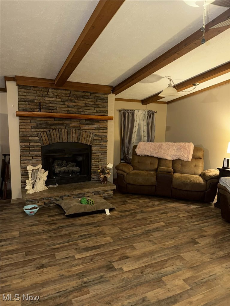 56 3rd Street Rayland, OH 43943 - Photo 45 of 46 Living room featuring a fireplace, beam ceiling, and dark wood-style floors