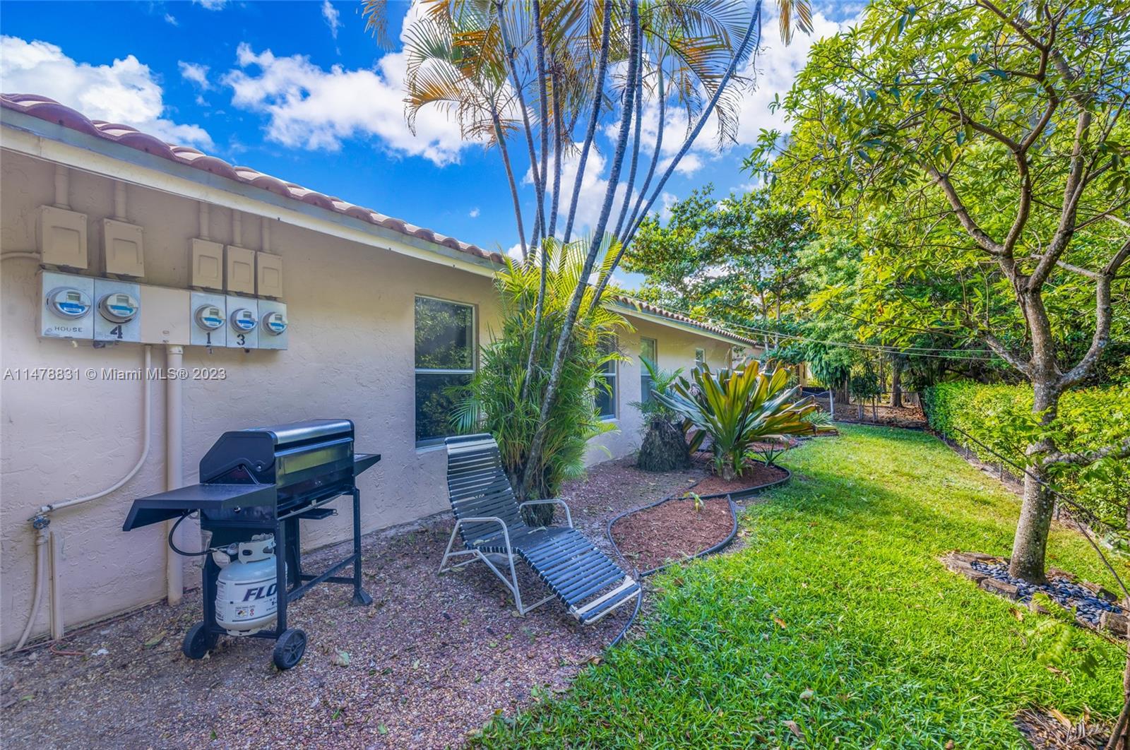 3504 Riverside Drive Coral Springs, FL 33065 - Photo 4 of 33 a view of a backyard with plants and a patio