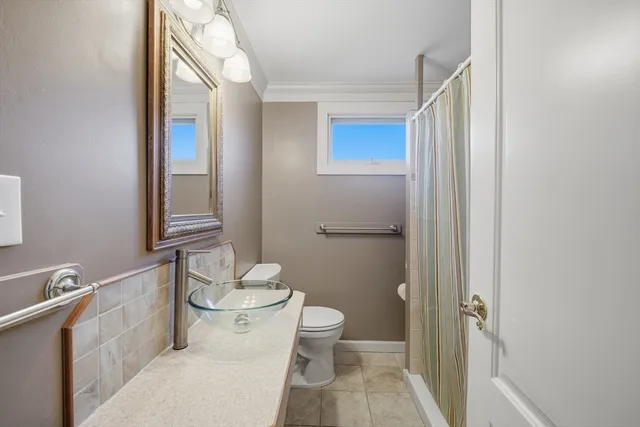 a bathroom with a toilet a sink and a mirror