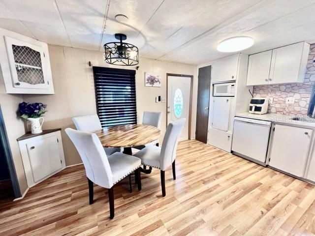 10819 London Drive Port Richey, FL 34668 - Photo 12 of 52 a view of a kitchen with a dining table chairs and entryway