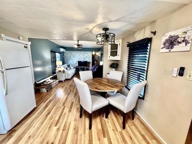 10819 London Drive Port Richey, FL 34668 - Photo 16 of 52 a living room with dining room and wooden floor