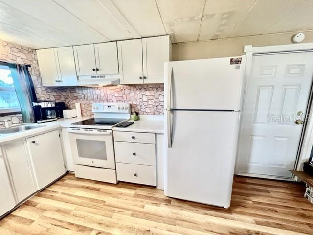 10819 London Drive Port Richey, FL 34668 - Photo 19 of 52 a white refrigerator freezer sitting in a kitchen