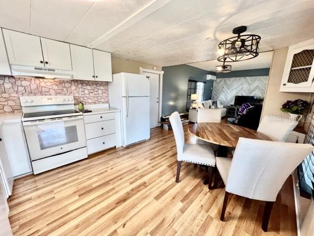 10819 London Drive Port Richey, FL 34668 - Photo 20 of 52 a dining room with furniture a fireplace and wooden floor