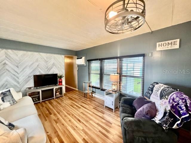 10819 London Drive Port Richey, FL 34668 - Photo 22 of 52 a living room with furniture and a flat screen tv