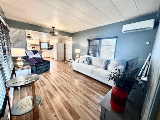 10819 London Drive Port Richey, FL 34668 - Photo 26 of 52 a living room with furniture and a floor to ceiling window