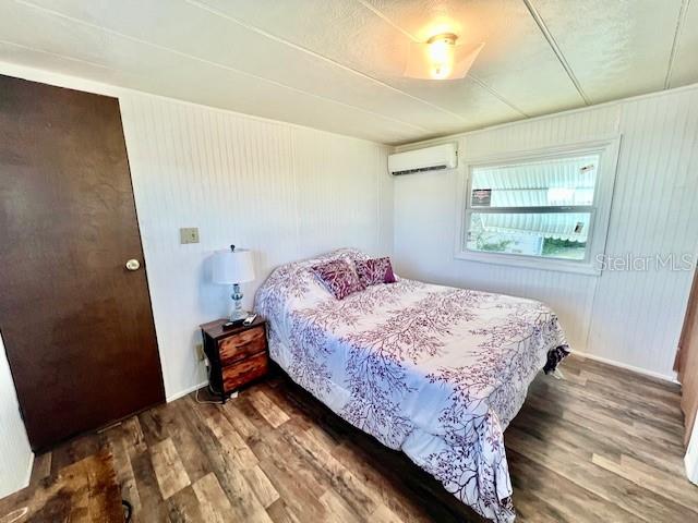 10819 London Drive Port Richey, FL 34668 - Photo 28 of 52 a bedroom with a bed and wooden floor