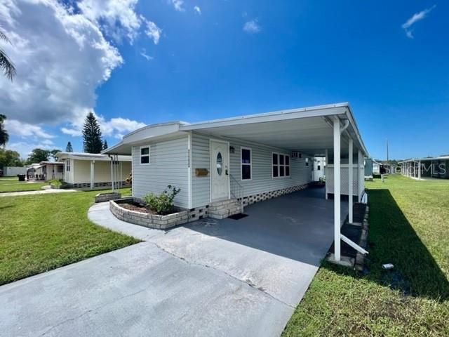 10819 London Drive Port Richey, FL 34668 - Photo 3 of 52 a front view of a house with garden