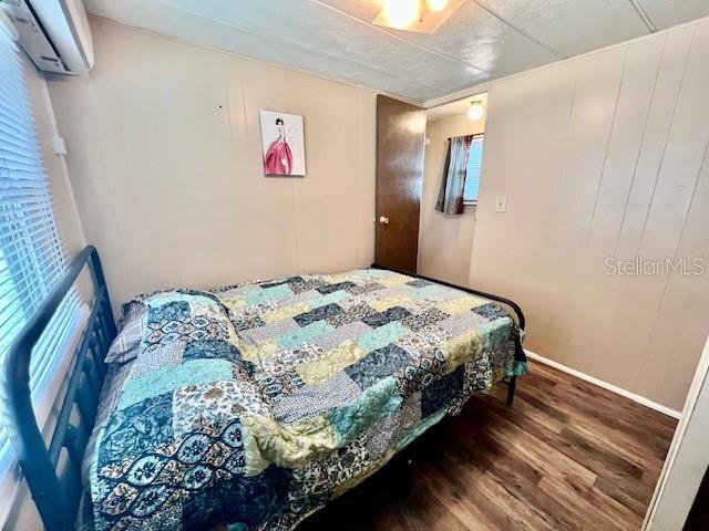 10819 London Drive Port Richey, FL 34668 - Photo 33 of 52 a bedroom with a bed and a painting on the wall