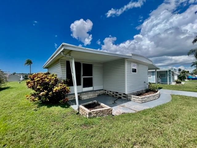 10819 London Drive Port Richey, FL 34668 - Photo 4 of 52 a front view of a house with a yard
