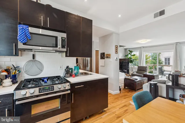 a kitchen with stainless steel appliances granite countertop a stove and a sink