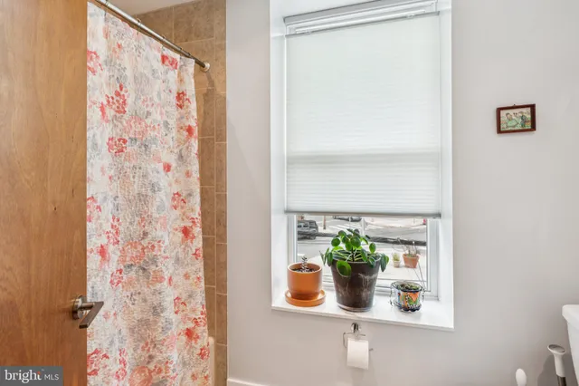 a white vase with flowers