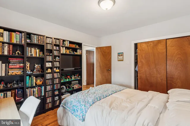 a bedroom with a bed and a book shelf