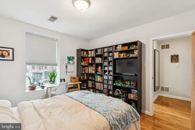 a bed room with a bed and a book shelf