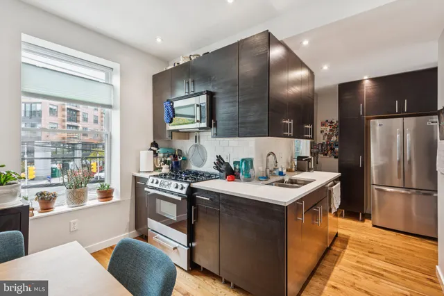 a kitchen with a stove a refrigerator and a sink
