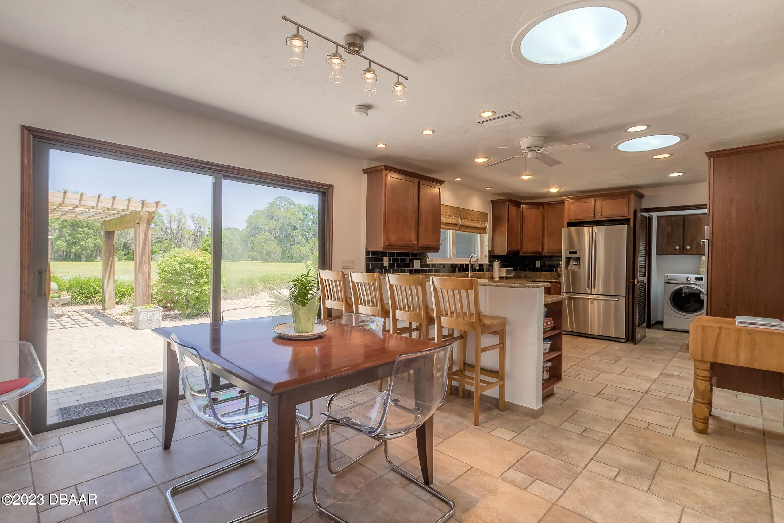 16 Eagle Court Ormond Beach, FL 32174 - Photo 12 of 50 a kitchen with stainless steel appliances kitchen island granite countertop a refrigerator and cabinets