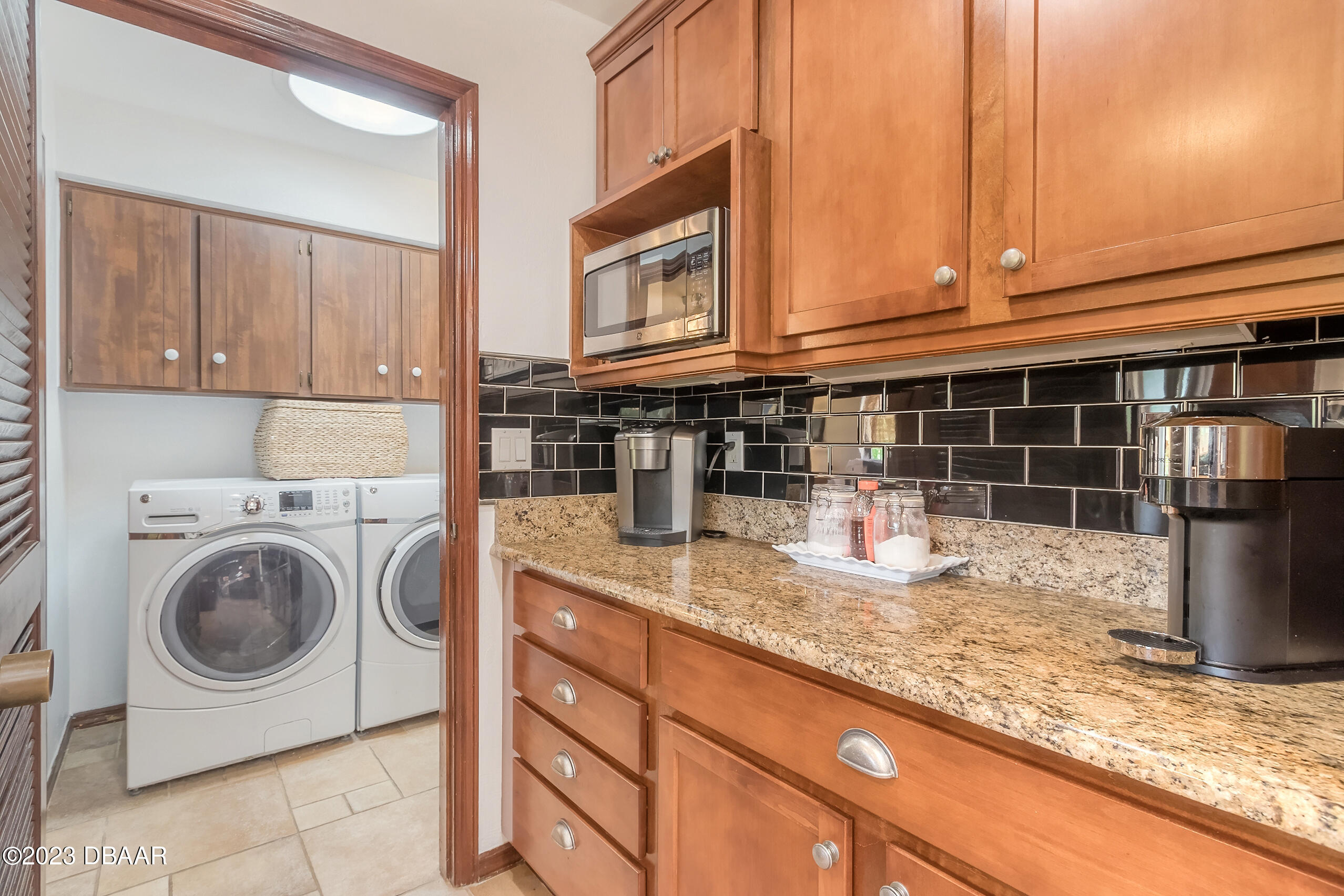 16 Eagle Court Ormond Beach, FL 32174 - Photo 18 of 50 a kitchen with granite countertop a sink and a stove top oven