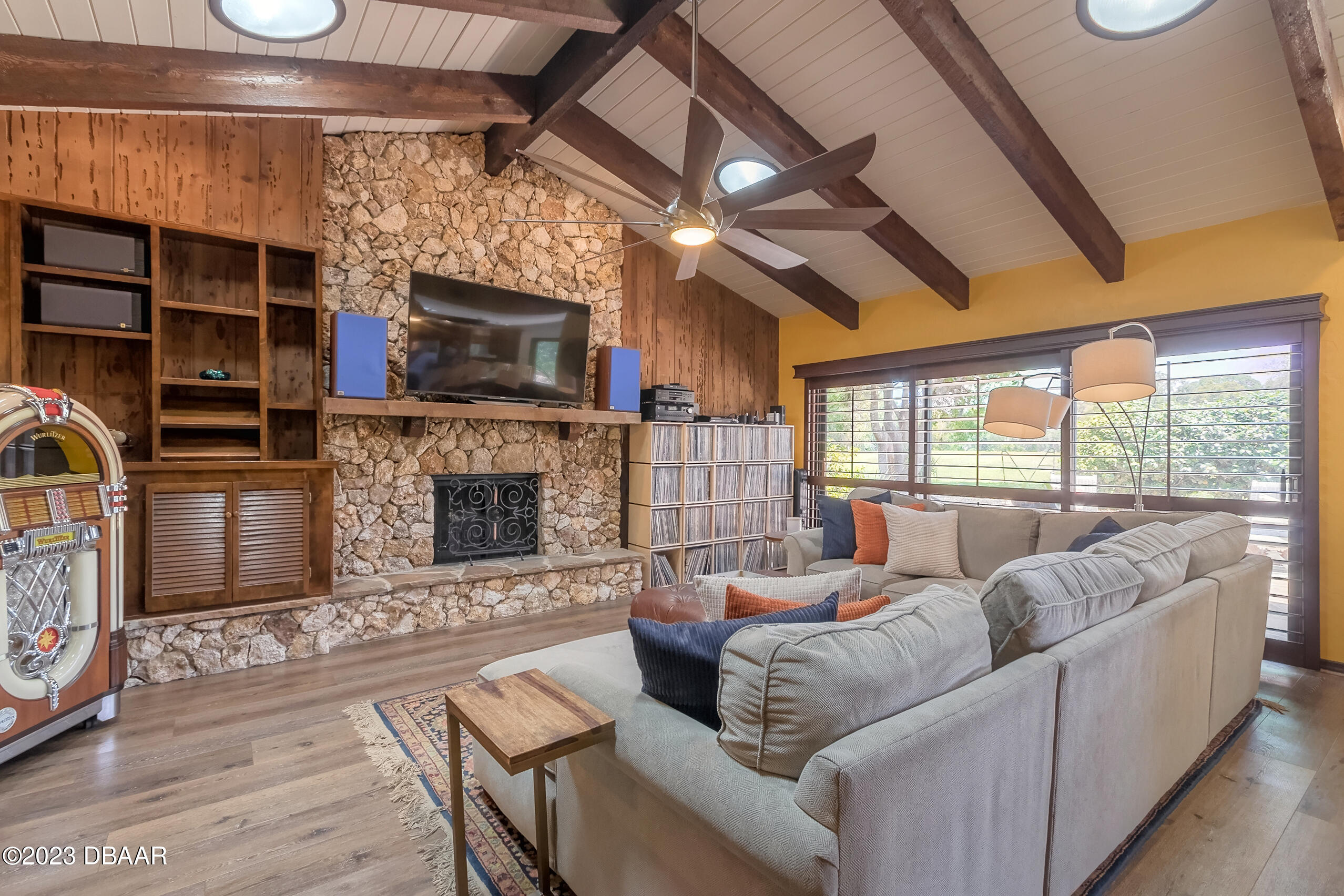 16 Eagle Court Ormond Beach, FL 32174 - Photo 23 of 50 a living room with furniture a flat screen tv and a fireplace