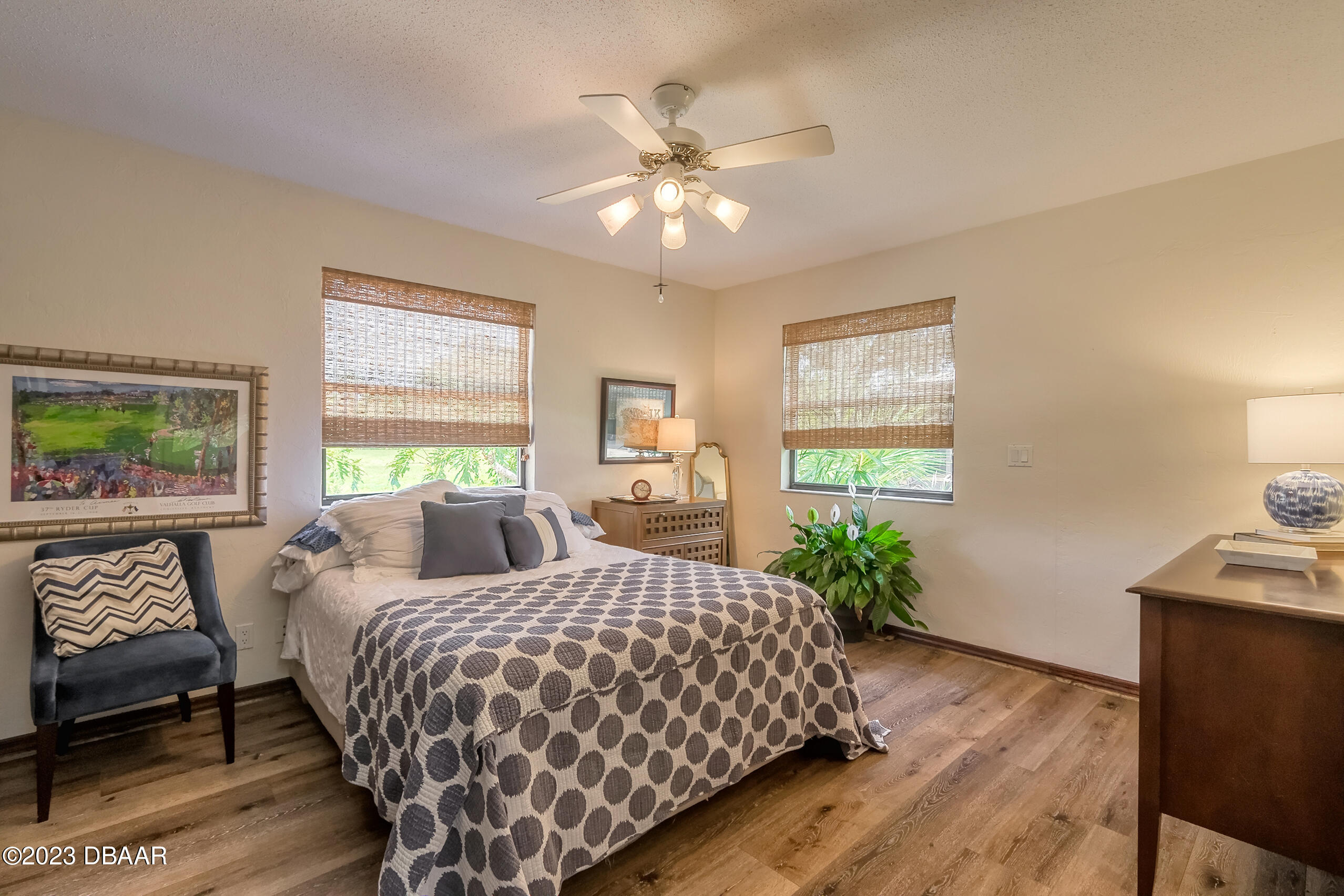 16 Eagle Court Ormond Beach, FL 32174 - Photo 27 of 50 a bedroom with a large bed and a chandelier
