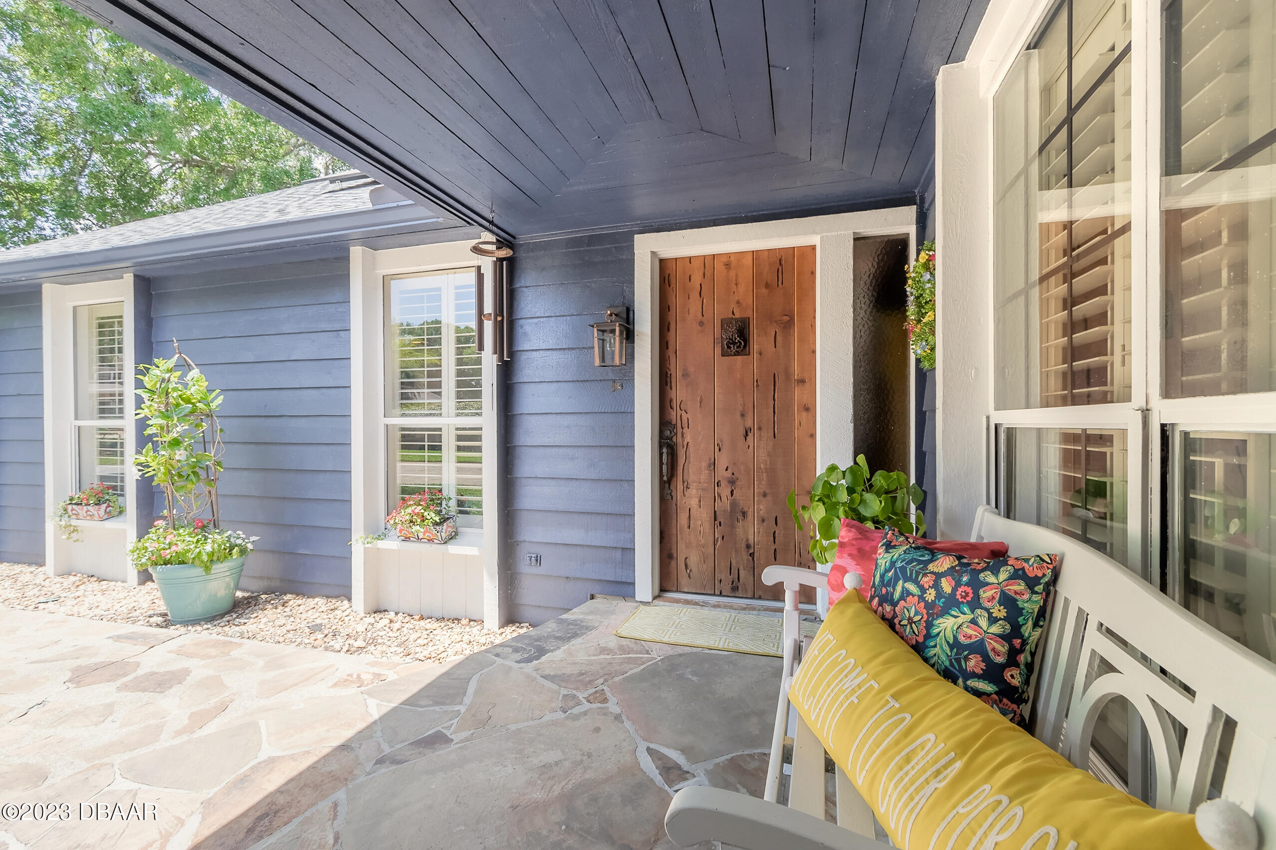 16 Eagle Court Ormond Beach, FL 32174 - Photo 3 of 50 a view of a porch with chairs potted plants