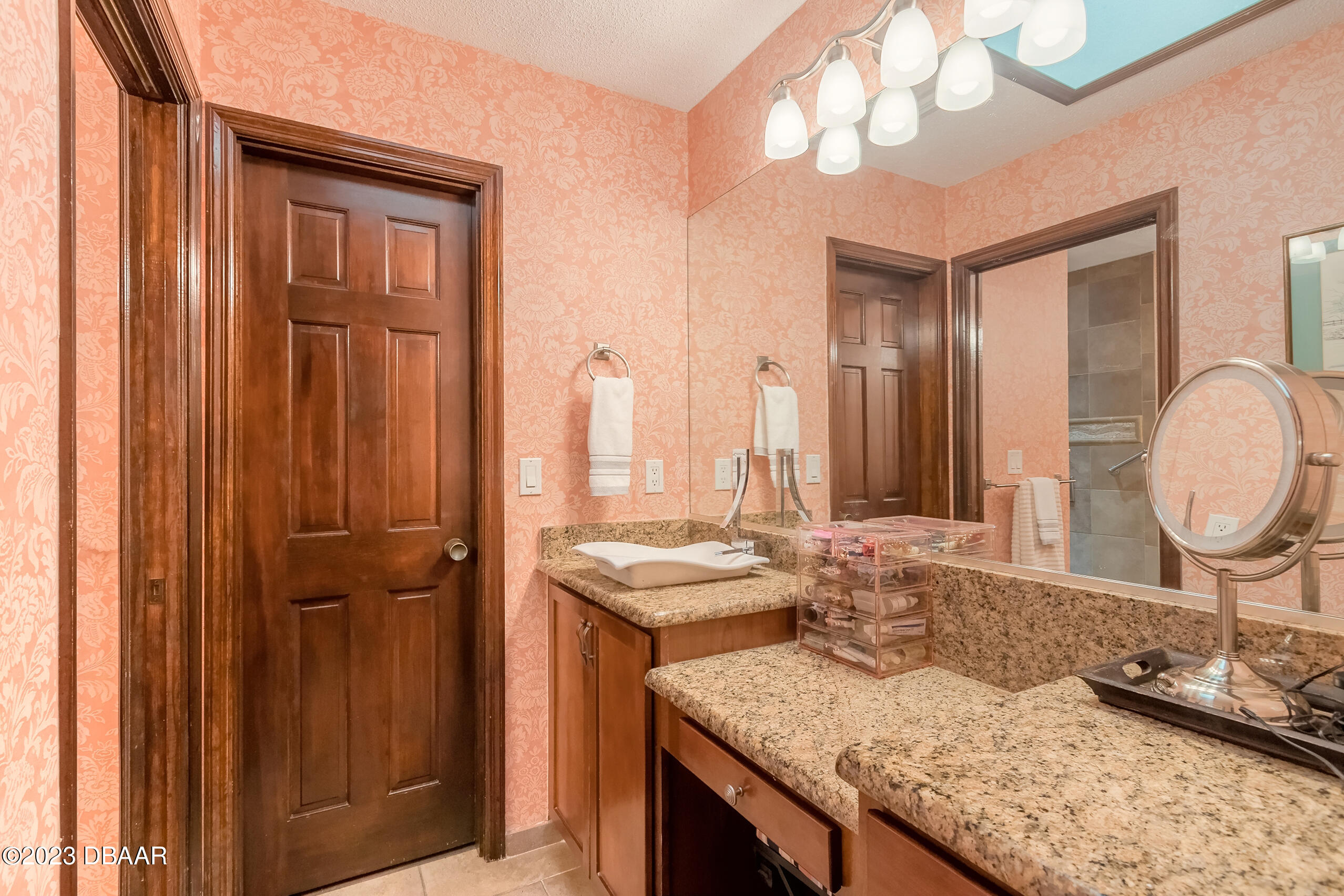16 Eagle Court Ormond Beach, FL 32174 - Photo 9 of 50 a bathroom with a granite countertop sink and a mirror