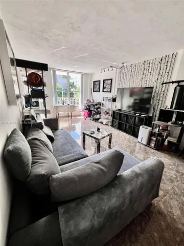 a living room with furniture fireplace and a large window