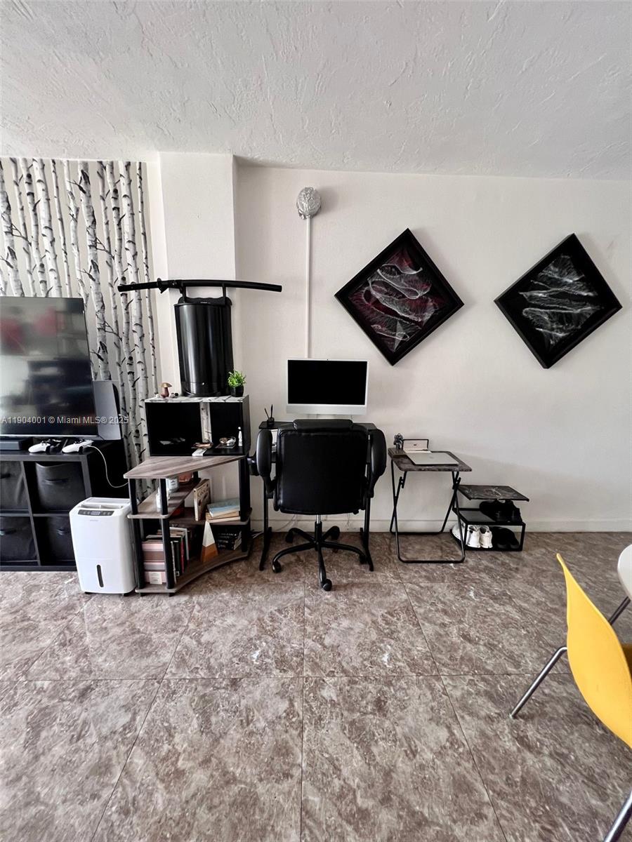 1300 Lincoln Road, Unit D304 Miami Beach, FL 33139 - Photo 12 of 24 a living room with furniture and a flat screen tv