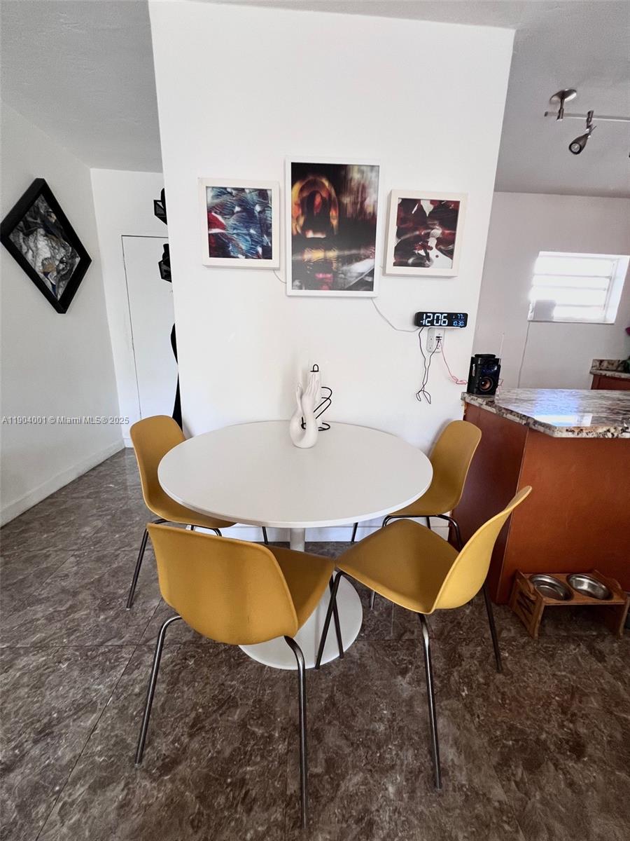 1300 Lincoln Road, Unit D304 Miami Beach, FL 33139 - Photo 14 of 24 a dining room with furniture and wooden floor
