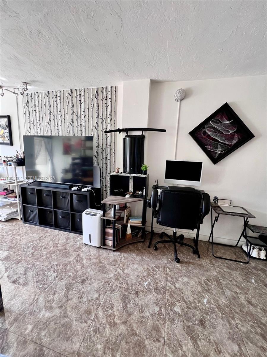 1300 Lincoln Road, Unit D304 Miami Beach, FL 33139 - Photo 17 of 25 a living room with furniture and a flat screen tv