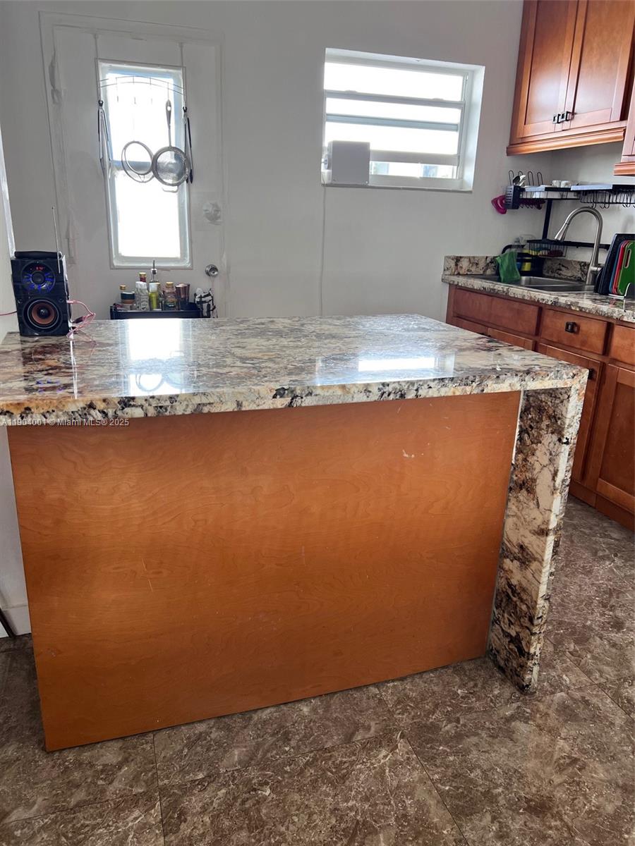 1300 Lincoln Road, Unit D304 Miami Beach, FL 33139 - Photo 17 of 24 a room with stainless steel appliances granite countertop a sink a stove a granite counter tops and a window