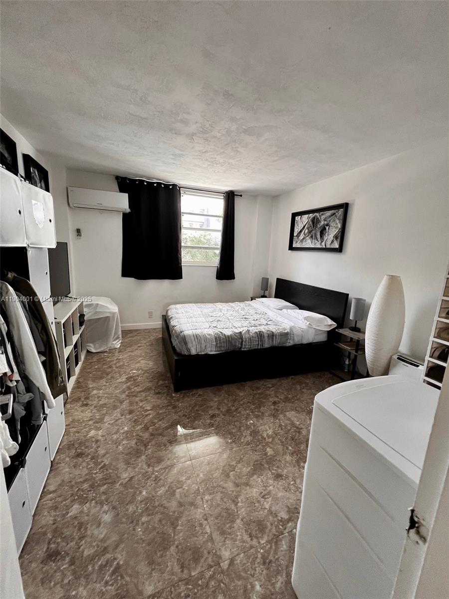 1300 Lincoln Road, Unit D304 Miami Beach, FL 33139 - Photo 19 of 24 a bedroom with two beds and a couch