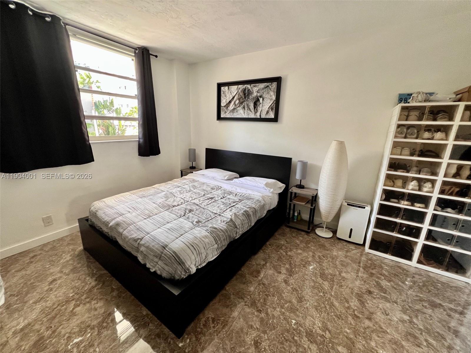 1300 Lincoln Road, Unit D304 Miami Beach, FL 33139 - Photo 22 of 25 a bedroom with a bed and a flat screen tv