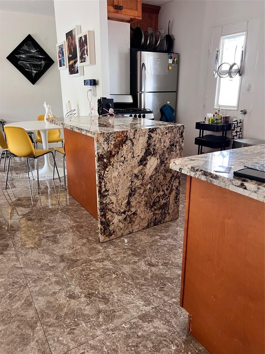 1300 Lincoln Road, Unit D304 Miami Beach, FL 33139 - Photo 22 of 24 a kitchen with stainless steel appliances granite countertop a stove a sink and a refrigerator