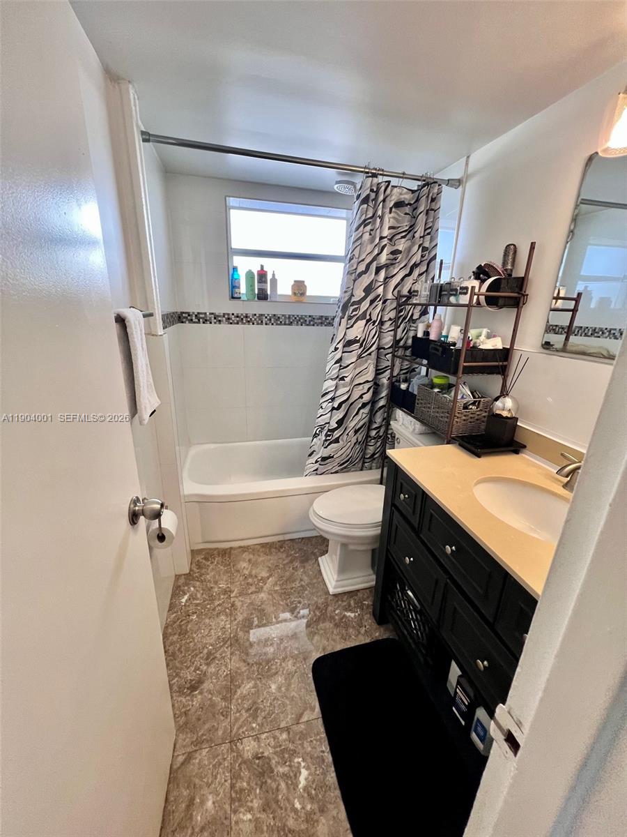 1300 Lincoln Road, Unit D304 Miami Beach, FL 33139 - Photo 23 of 25 a bathroom with a sink toilet and shower